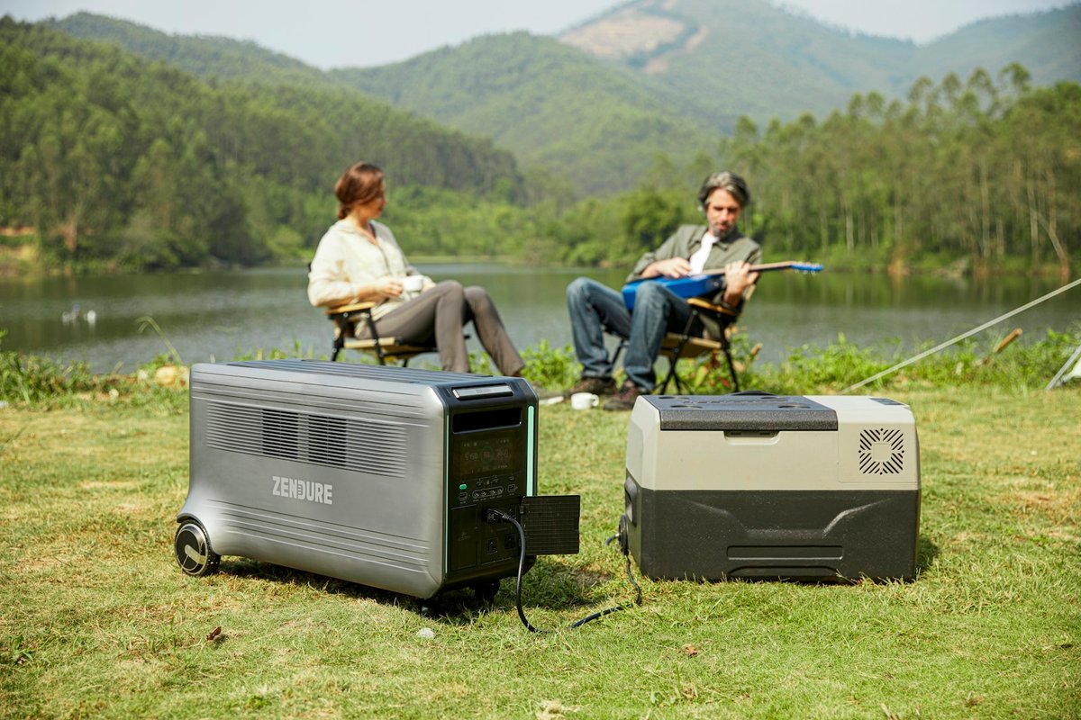 Couple sitting by a lake with camping gear