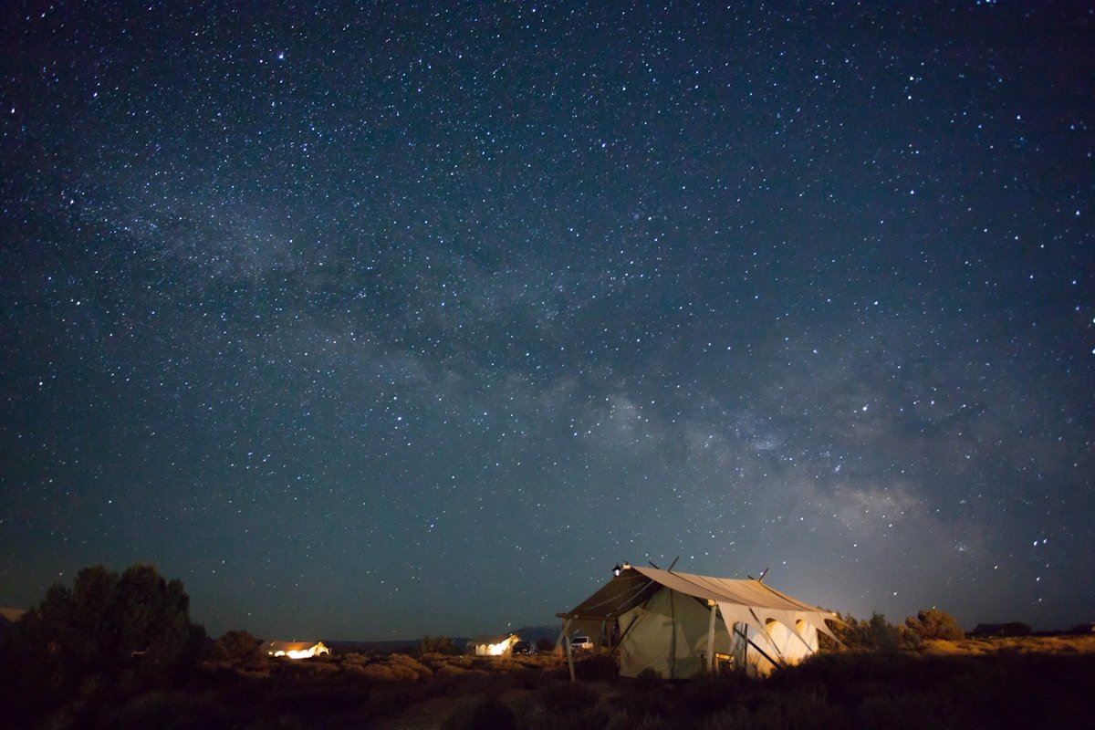 Brown tent under a starry night sky